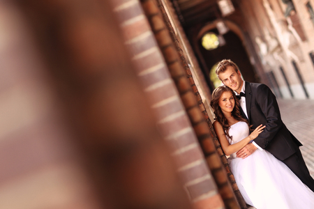Beautiful bridal couple embracing in the cityの写真素材
