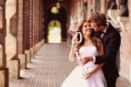 Beautiful bride and groom embracing in the cityの写真素材