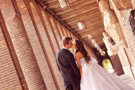 Beautiful bridal couple embracing in the cityの写真素材