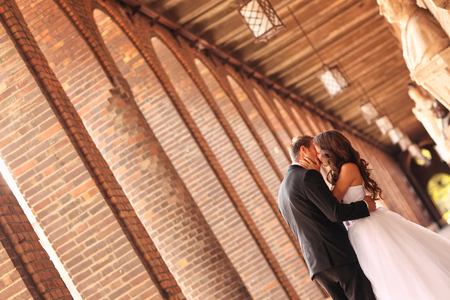 Beautiful bridal couple embracing in the cityの写真素材