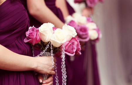 Bridesmaids holding beautiful bouquet of flowersの写真素材