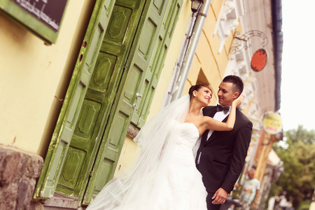 Beautiful bride and groom celebrating their wedding day in the cityの写真素材