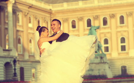 Beautiful bride and groom celebrating their wedding day in the cityの写真素材