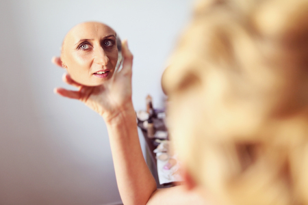 Joyful bride getting professional make up before weddingの写真素材