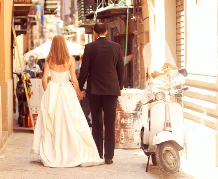 Joyful  bride and groom embracing in old cityの写真素材