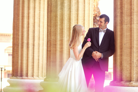 Joyful  bride and groom embracing in old cityの写真素材