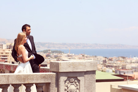 Joyful  bride and groom embracing in old cityの写真素材