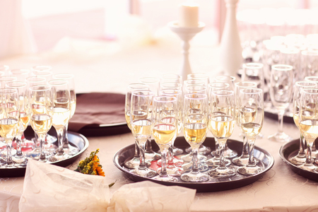 Many glasses of champagne on tray at wedding receptionの写真素材