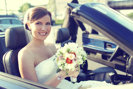 Beautiful bride with bouqut posing on wedding dayの写真素材