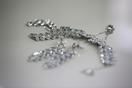Elegant crystal ear-rings for the bride on isolated backgroundの写真素材