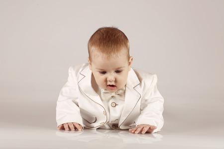 Little baby boy in tuxedo smiling and having funの写真素材