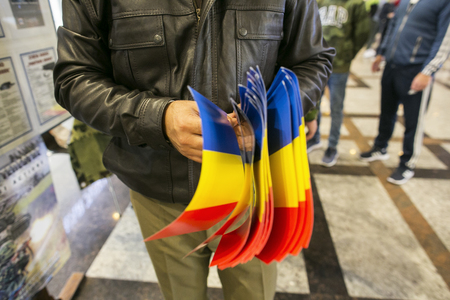 Man holding a lot of romanian flagの写真素材