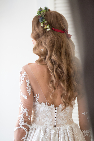 Beautiful blonde bride posing in luxury wedding dressの写真素材