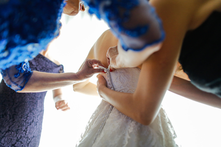 Bridesmaid fixing button dress weddingの写真素材