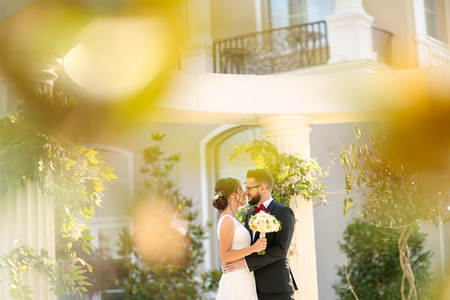 Beautiful wedding couple posing outdoor near luxury structureの写真素材