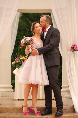 Beautiful wedding couple posing near pavilionの写真素材