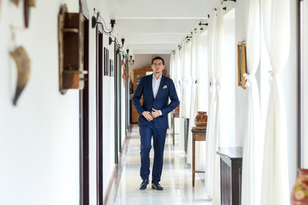 Happy groom in the hall of the hotelの写真素材