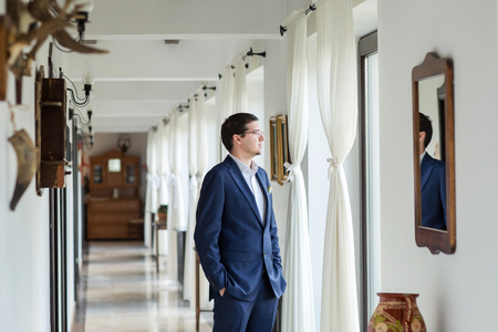 Happy groom in the hall of the hotelの写真素材