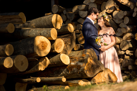 Happy wedding couple posing in nature with woodsの写真素材