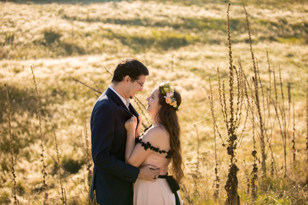 Beautiful wedding couple posing in green yardの写真素材