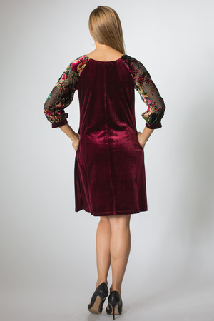 Blonde model posing in cherry-colour dressの写真素材