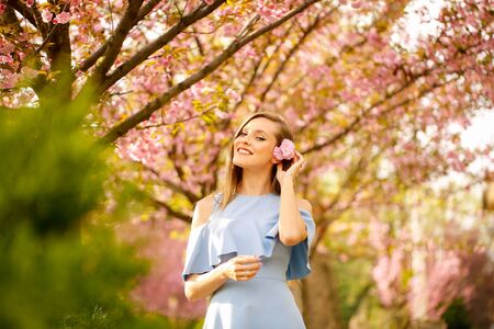 Beautiful blonde girl posing outdoor in parkの写真素材