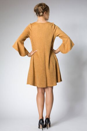 Beautiful blonde model posing in yellow long dressの写真素材