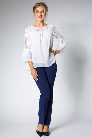 Beautiful blonde model posing in white shirt and blue pantsの写真素材