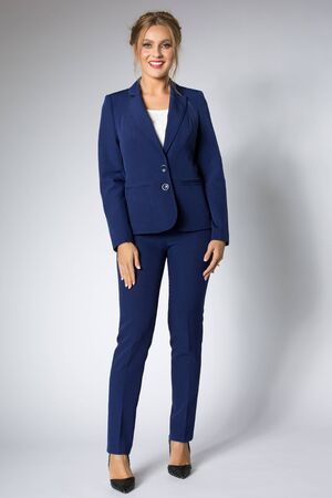 Beautiful woman posing in blue tuxedoの写真素材