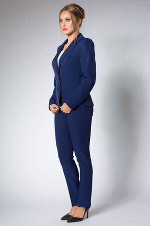 Beautiful woman posing in blue tuxedoの写真素材