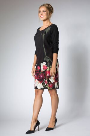 Blonde woman posing in long dress with flowers designの写真素材