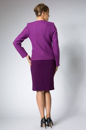Beautiful blonde girl posing in purple dressの写真素材