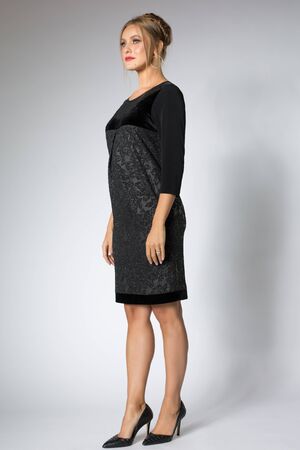 Beautiful blonde girl posing in luxury black dressの写真素材