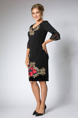 Beautiful blonde girl posing in luxury black dressの写真素材