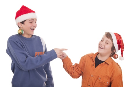 Happy young friends laughing and wearing Christmas hatâsの写真素材