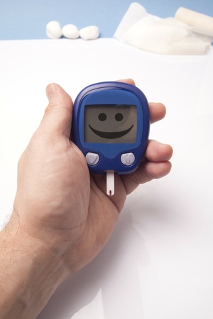 Funny Glucometer In A Human Hand.  Bandages In The Backgroundの写真素材