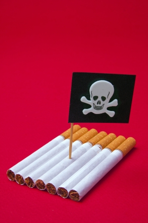 Boat made of Cigarettes with death flag on red backgroundの写真素材