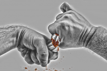 Human hands violently breaking cigarettes Anti smoking conceptの写真素材