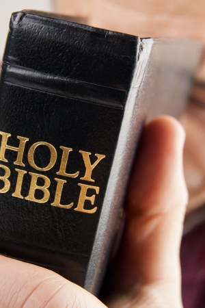 Man Praying Holding the Bible