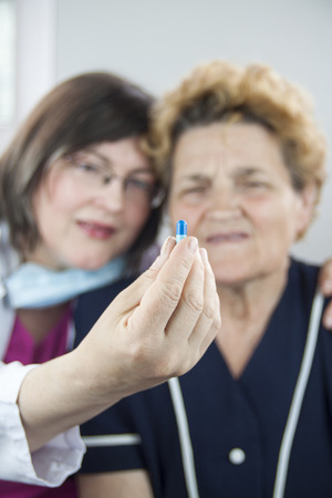 Woman doctor and patient. Holding pillの写真素材