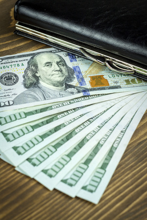 US dollars and wallet. Wood backgroundの写真素材