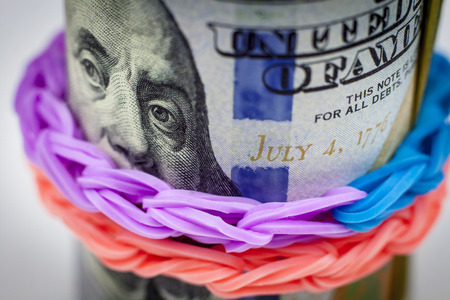 Bundle of money with loom bands. Close viewの写真素材