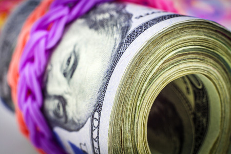 Bundle of money with loom bands. Close view