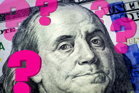 Benjamin Franklin's portrait and question marks expressing financial uncertainty - Financial conceptの写真素材