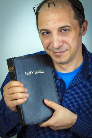 Portrait of a Man Holding Holy Bible
