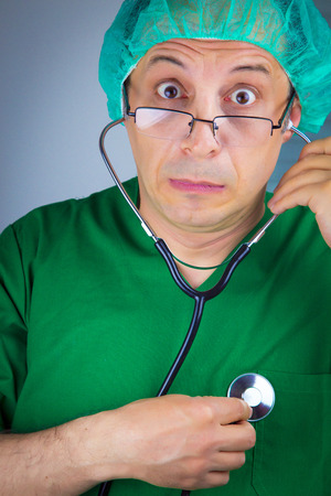 Portrait of doctor surgeon with stethoscope. Funny photo. Isolatedの写真素材