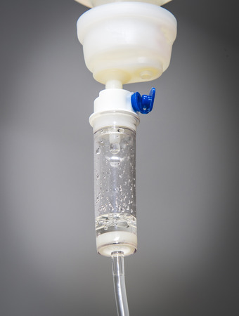 Saline Drip bottle for Intravenous Antibiotics therapy. Infusion solution with needle in itの写真素材