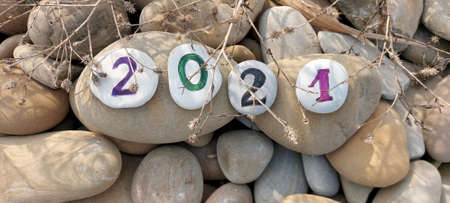 Year of the bull. Numbers 2021 written on sea pebbles.の写真素材