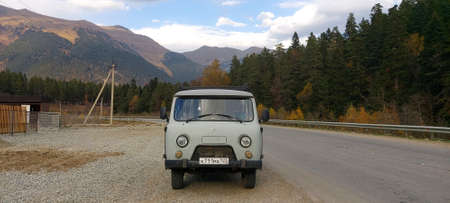 Camper-UAZ on the background of a mountain autumn road. Travel, vacation.のeditorial素材