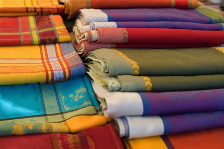 A stall of table clothes in an outdoor marketの写真素材